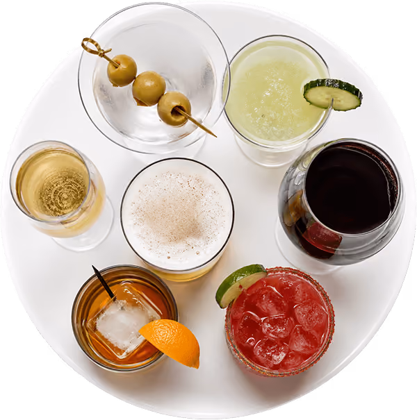 Top-down view of handcrafted cocktails, including a martini, margarita, Bloody Mary, and classic mixed drinks.