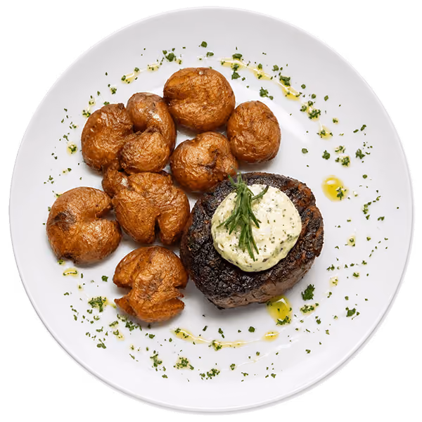 Grilled filet mignon served with roasted baby potatoes and creamy herb butter for a classic steakhouse favorite.