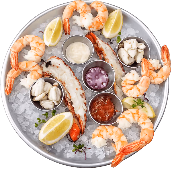Fresh seafood platter with oysters, shrimp, clams, cocktail sauce, mignonette, and lemon wedges on ice.