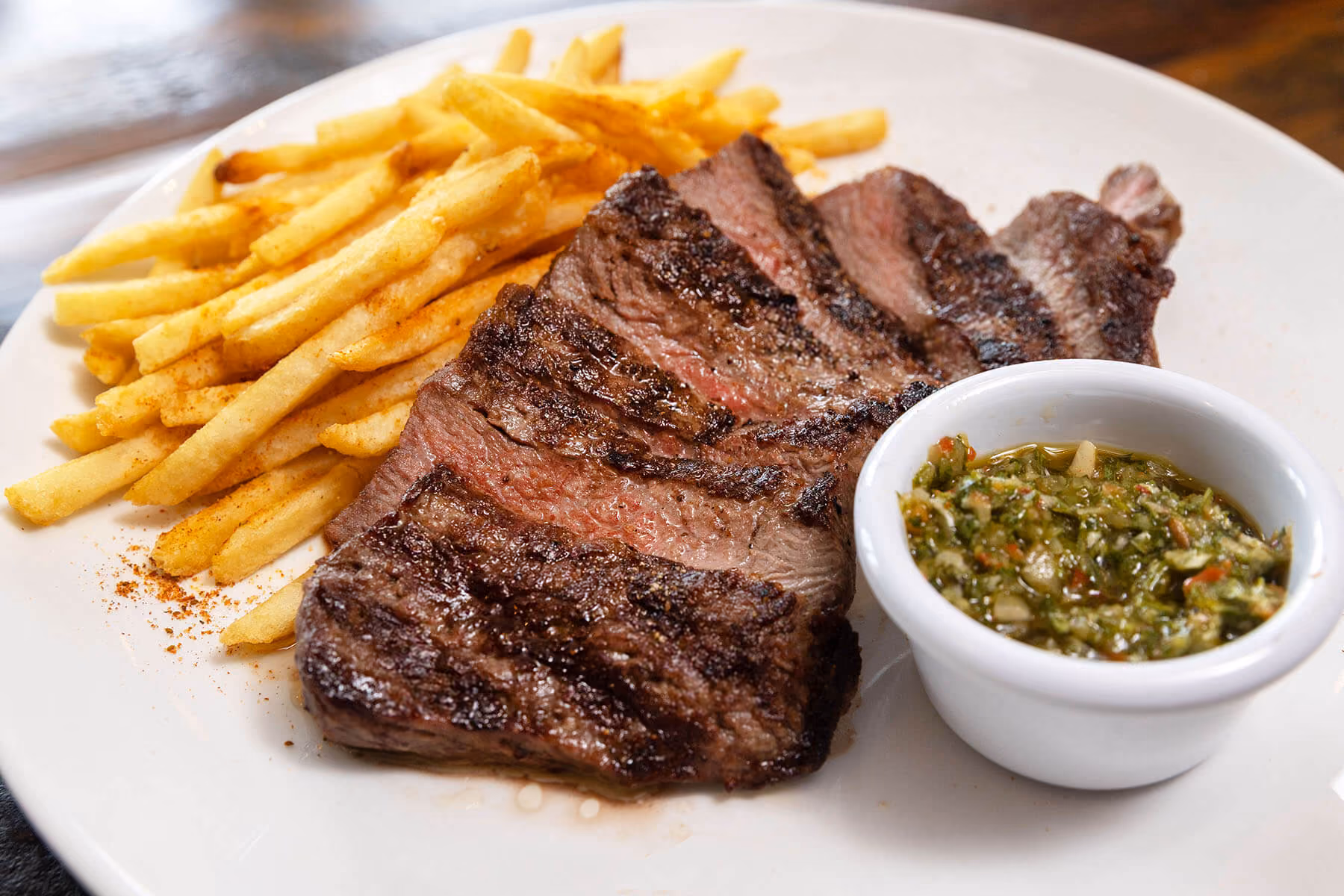 Grilled steak with fries and chimichurri