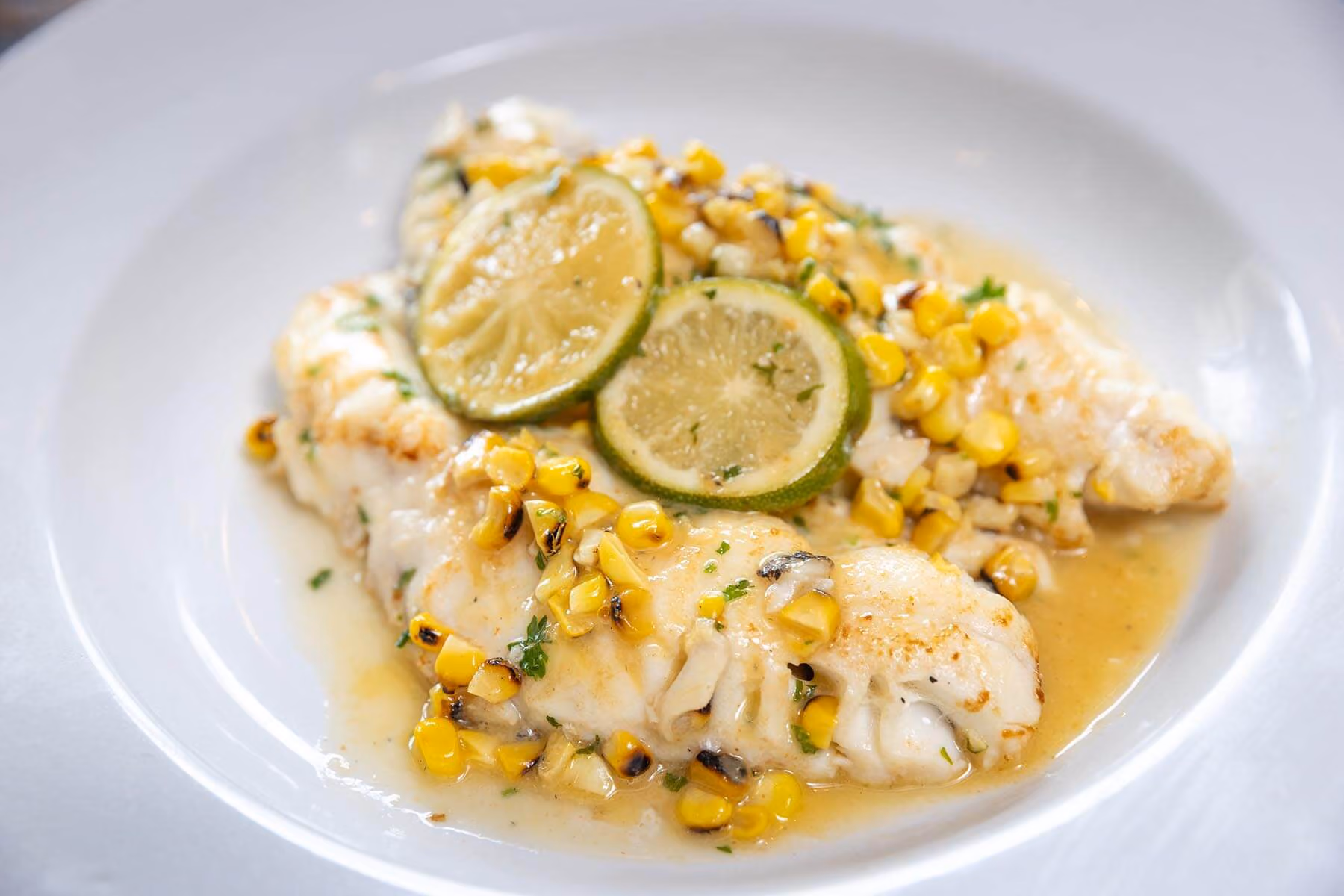 Pan-seared Chilean sea bass with corn succotash